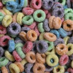 A bowl of colorful fruit-flavored loop cereal, used to illustrate how pantry pests can contaminate common household food items in Omaha, NE.