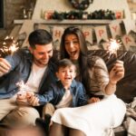 A happy family celebrating the holidays in Council Bluffs, Iowa with sparklers and festive decorations.
